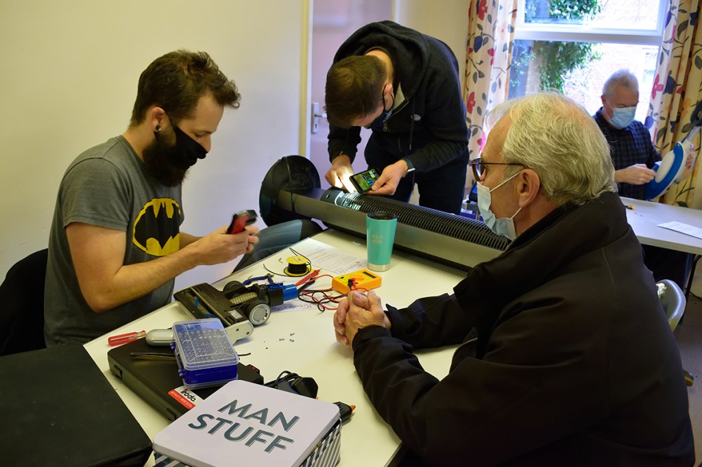 Nathan and Paul working on a vacuum and air conditioning unit.